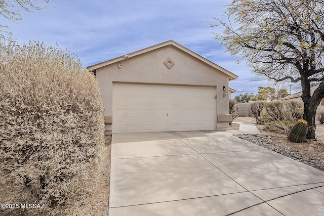 garage with concrete driveway