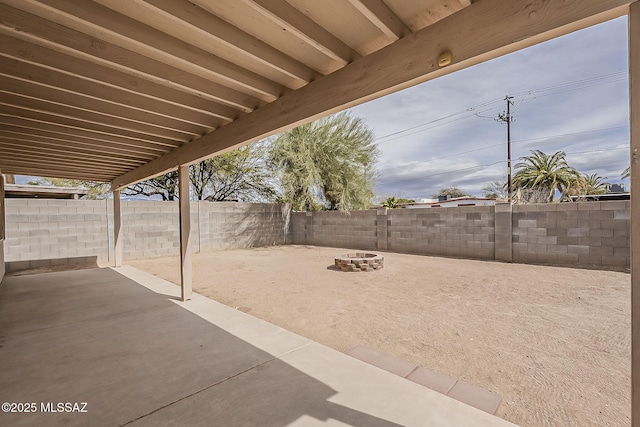 view of patio / terrace featuring a fenced backyard and a fire pit