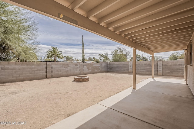 view of patio / terrace featuring a fenced backyard and a fire pit