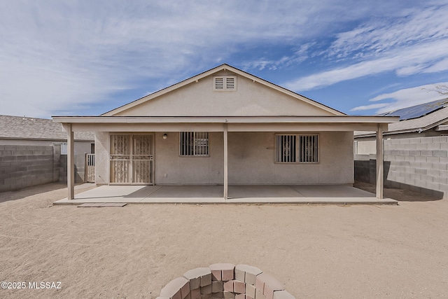 back of property with a patio, fence, and stucco siding