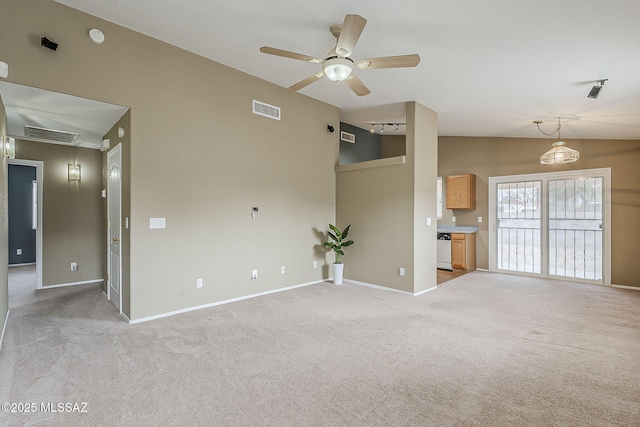 unfurnished living room with light carpet, lofted ceiling, visible vents, and baseboards