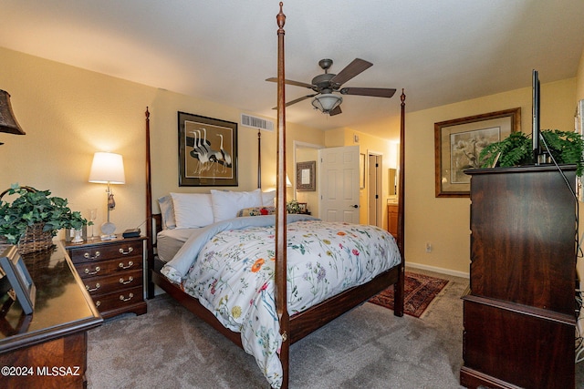 bedroom featuring dark colored carpet, connected bathroom, and ceiling fan