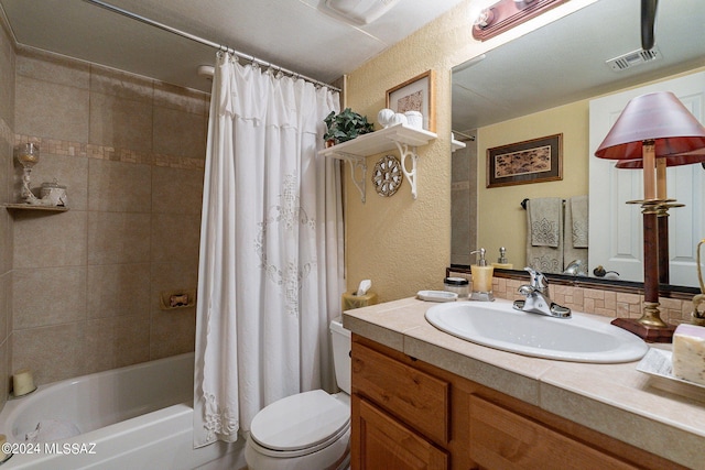 full bathroom featuring vanity, shower / tub combo, and toilet