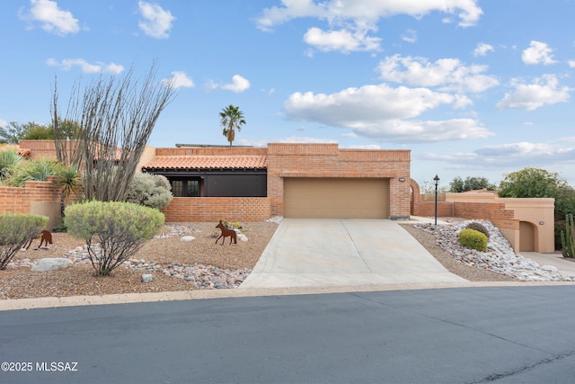 pueblo-style house featuring a garage