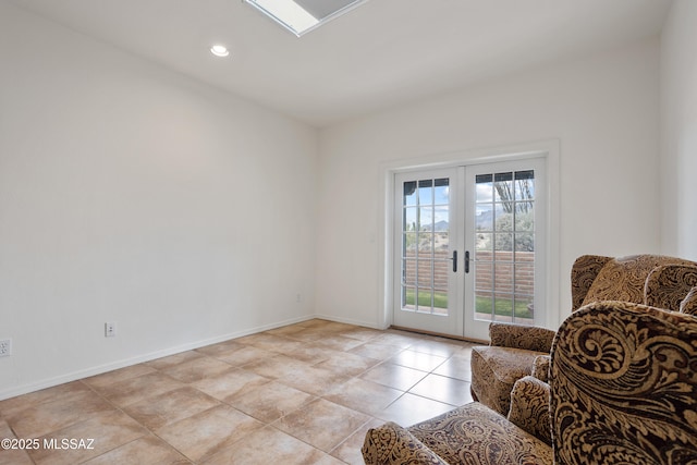 living area featuring french doors and light tile patterned flooring