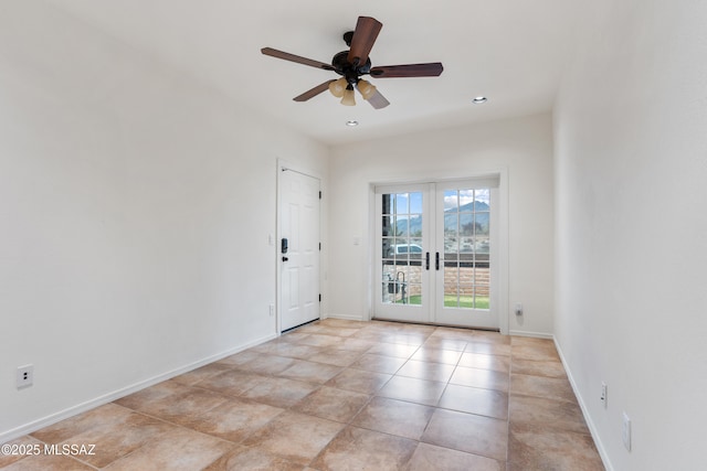 spare room with ceiling fan and french doors