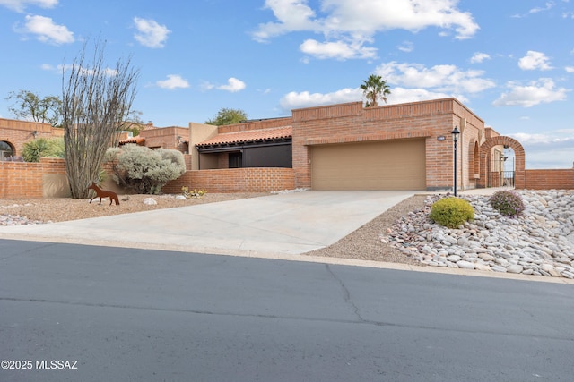 pueblo revival-style home with a garage