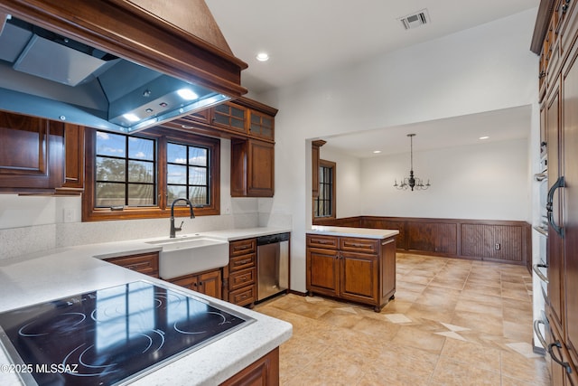 kitchen featuring an inviting chandelier, sink, hanging light fixtures, stainless steel dishwasher, and kitchen peninsula