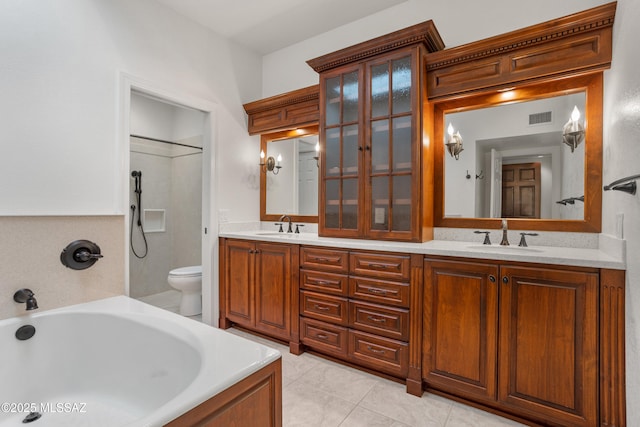 bathroom with tile patterned flooring, vanity, toilet, and a bathing tub