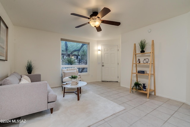 living room with ceiling fan and light tile patterned flooring