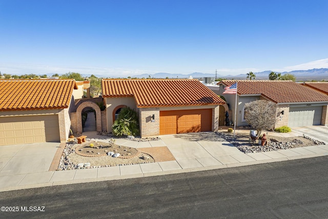 mediterranean / spanish house with a mountain view and a garage