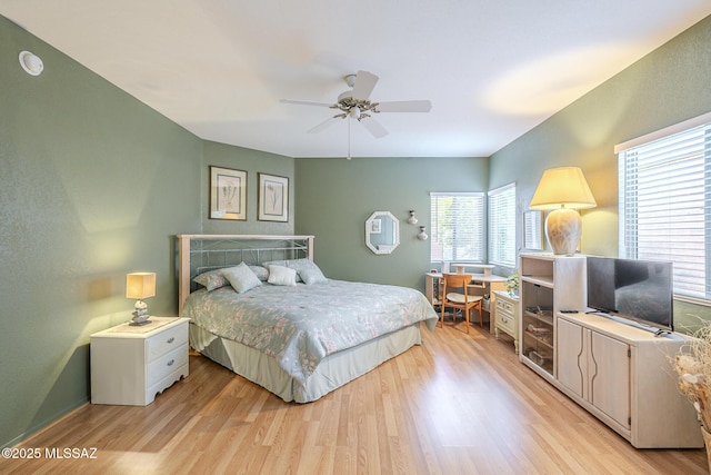 bedroom with light hardwood / wood-style flooring and ceiling fan