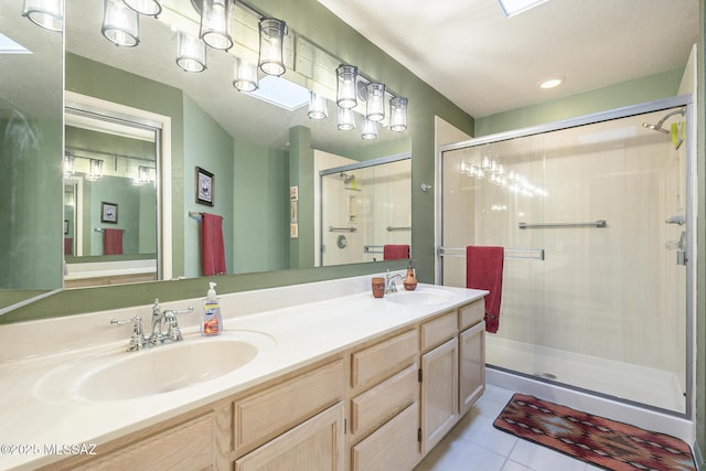 bathroom featuring tile patterned flooring, vanity, and a shower with door