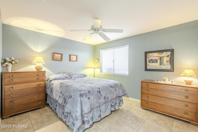 tiled bedroom featuring ceiling fan