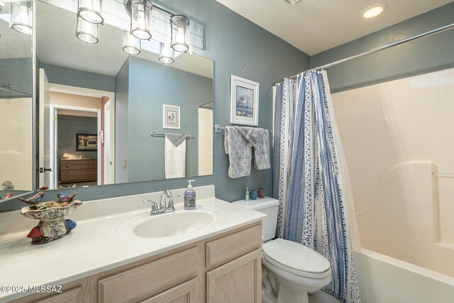 full bathroom with shower / tub combo, vanity, and toilet