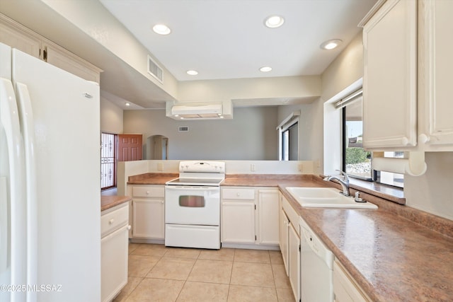 kitchen featuring recessed lighting, visible vents, light tile patterned flooring, a sink, and white appliances