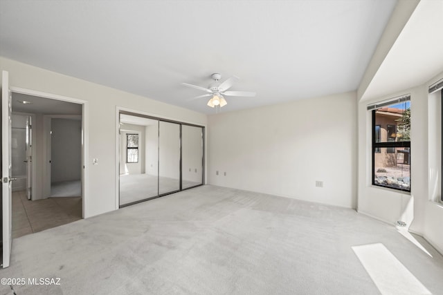 unfurnished bedroom with carpet and a ceiling fan