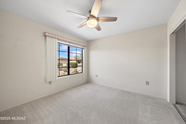 spare room featuring a ceiling fan, carpet flooring, and baseboards