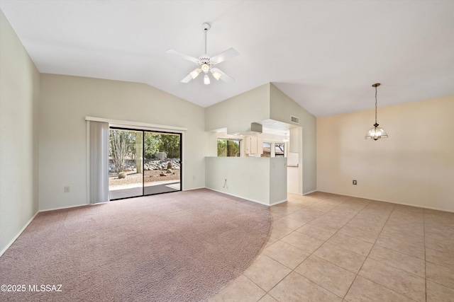 unfurnished living room with visible vents, light tile patterned flooring, light carpet, vaulted ceiling, and ceiling fan