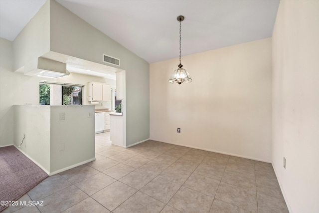 unfurnished room with vaulted ceiling, light tile patterned flooring, a chandelier, and visible vents