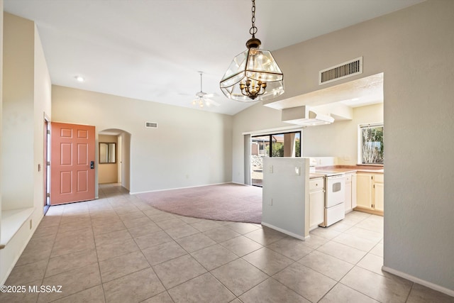 kitchen featuring lofted ceiling, white range with electric cooktop, arched walkways, and visible vents