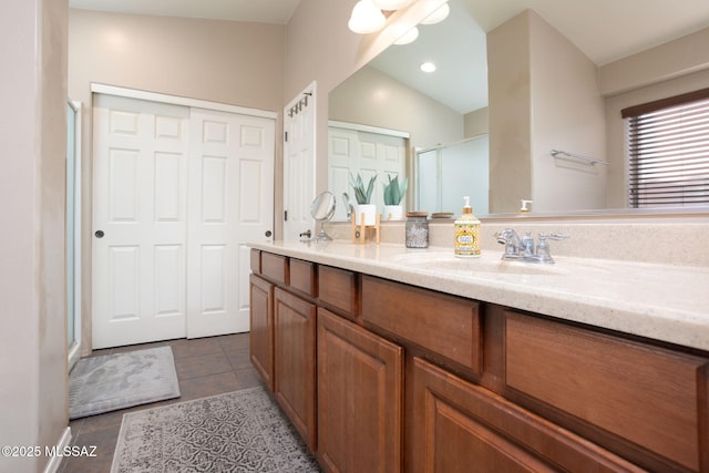 bathroom featuring vanity, vaulted ceiling, tile patterned flooring, ceiling fan, and walk in shower