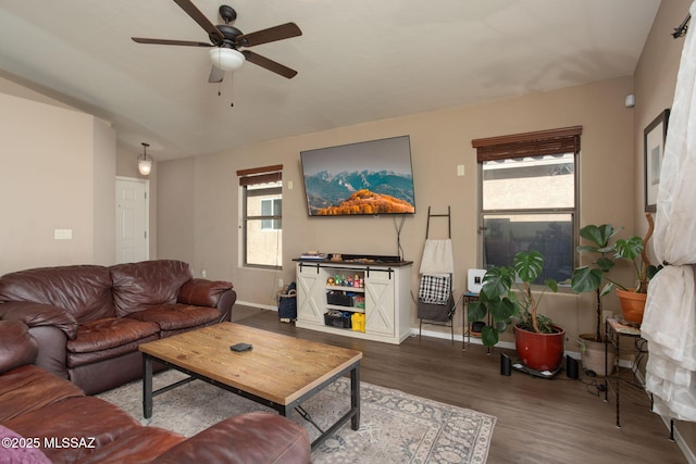 living room featuring wood-type flooring, lofted ceiling, ceiling fan, and a healthy amount of sunlight