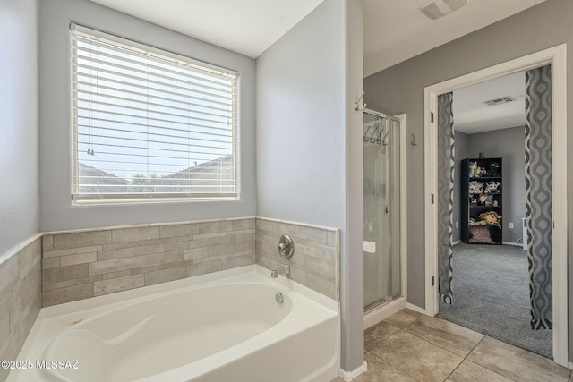 bathroom with tile patterned floors and independent shower and bath