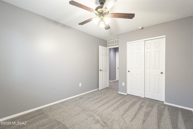 unfurnished bedroom featuring carpet, a closet, and ceiling fan