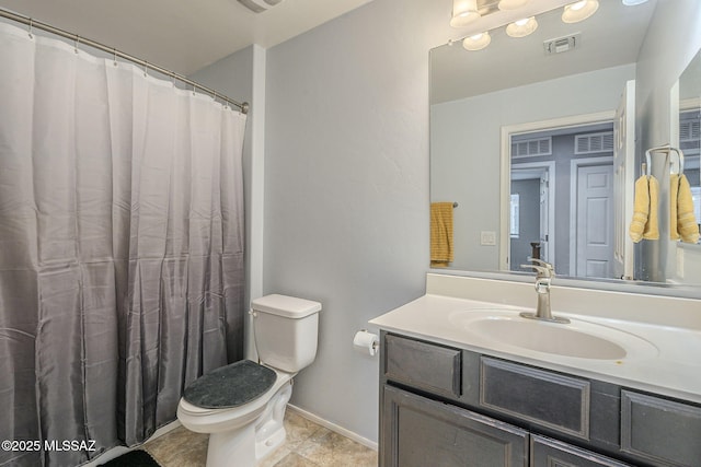 bathroom with tile patterned floors, vanity, and toilet