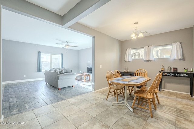 dining room featuring beamed ceiling, light tile patterned floors, and ceiling fan with notable chandelier
