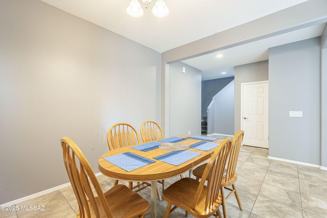 dining room with a notable chandelier and light tile patterned flooring