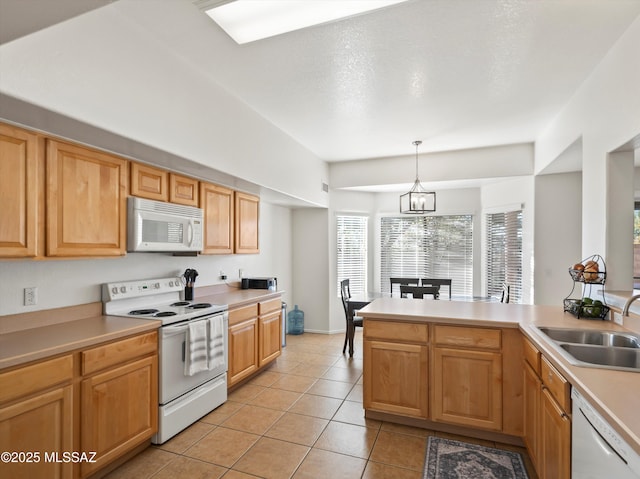 kitchen featuring pendant lighting, white appliances, an inviting chandelier, sink, and light tile patterned floors