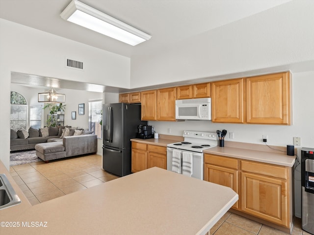 kitchen with an inviting chandelier, light tile patterned flooring, sink, and white appliances