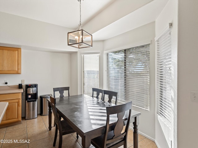 tiled dining space featuring a chandelier