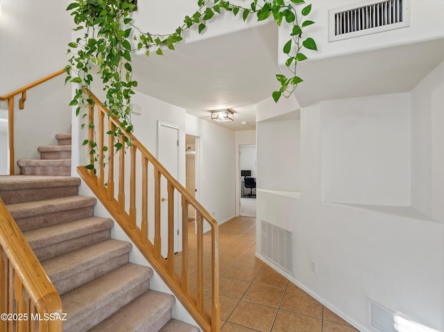 staircase with tile patterned flooring