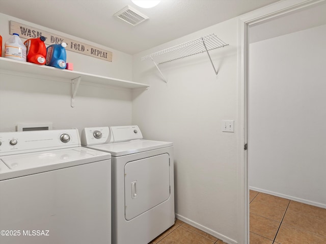 laundry room with separate washer and dryer and light tile patterned floors