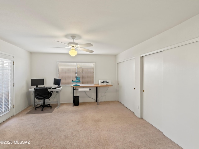 office featuring ceiling fan and light colored carpet