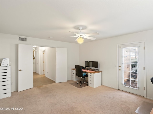 home office with light carpet and ceiling fan