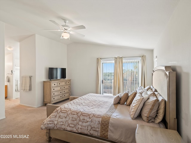 carpeted bedroom featuring ceiling fan, ensuite bath, and lofted ceiling