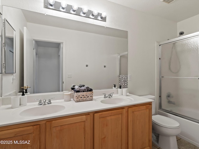 full bathroom with toilet, combined bath / shower with glass door, and vanity