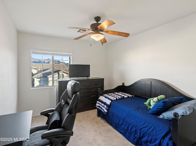 bedroom with ceiling fan and light carpet