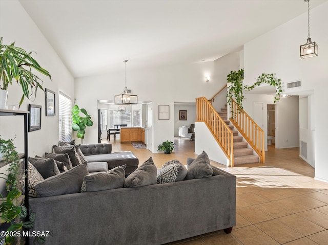 living room with high vaulted ceiling and tile patterned floors