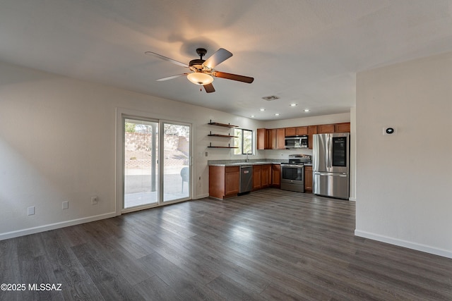 kitchen with visible vents, appliances with stainless steel finishes, brown cabinets, light countertops, and open shelves