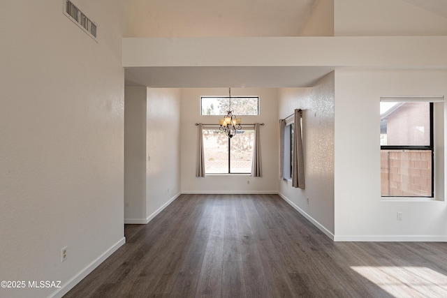 unfurnished room with dark hardwood / wood-style floors and a notable chandelier