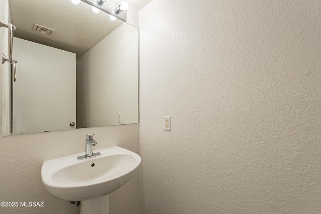 bathroom featuring sink and a textured ceiling