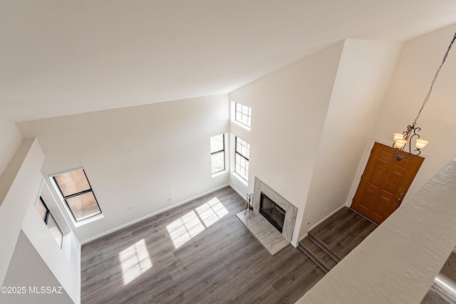 living room featuring a fireplace, high vaulted ceiling, and dark hardwood / wood-style floors