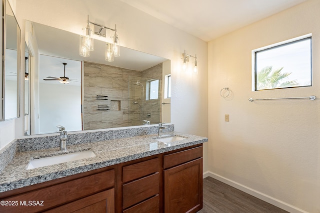 bathroom featuring walk in shower, vanity, hardwood / wood-style floors, and a wealth of natural light