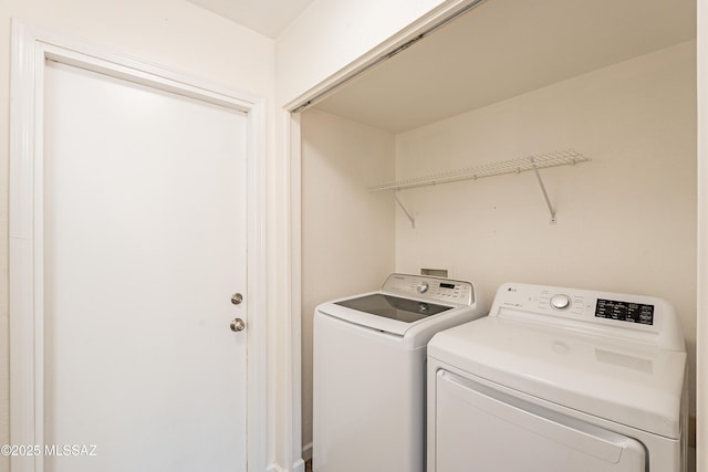 clothes washing area featuring washer and dryer