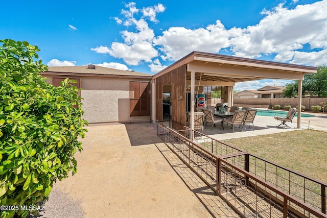 view of patio with a fenced in pool